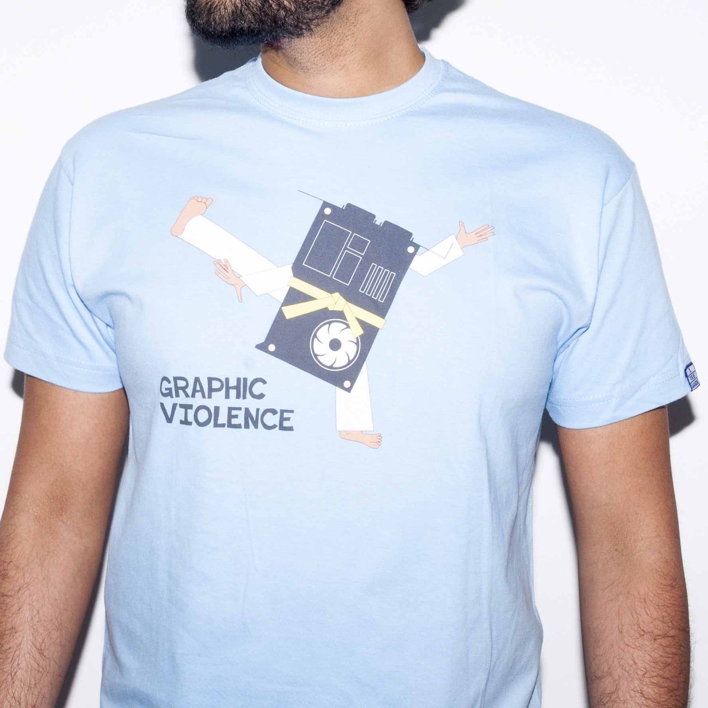 Light blue T-shirt with a funny computer nerd graphics card geek joke screen printed on the front. A graphics card in yellow belt martial arts uniform high kicks with slogan, graphic violence - below.