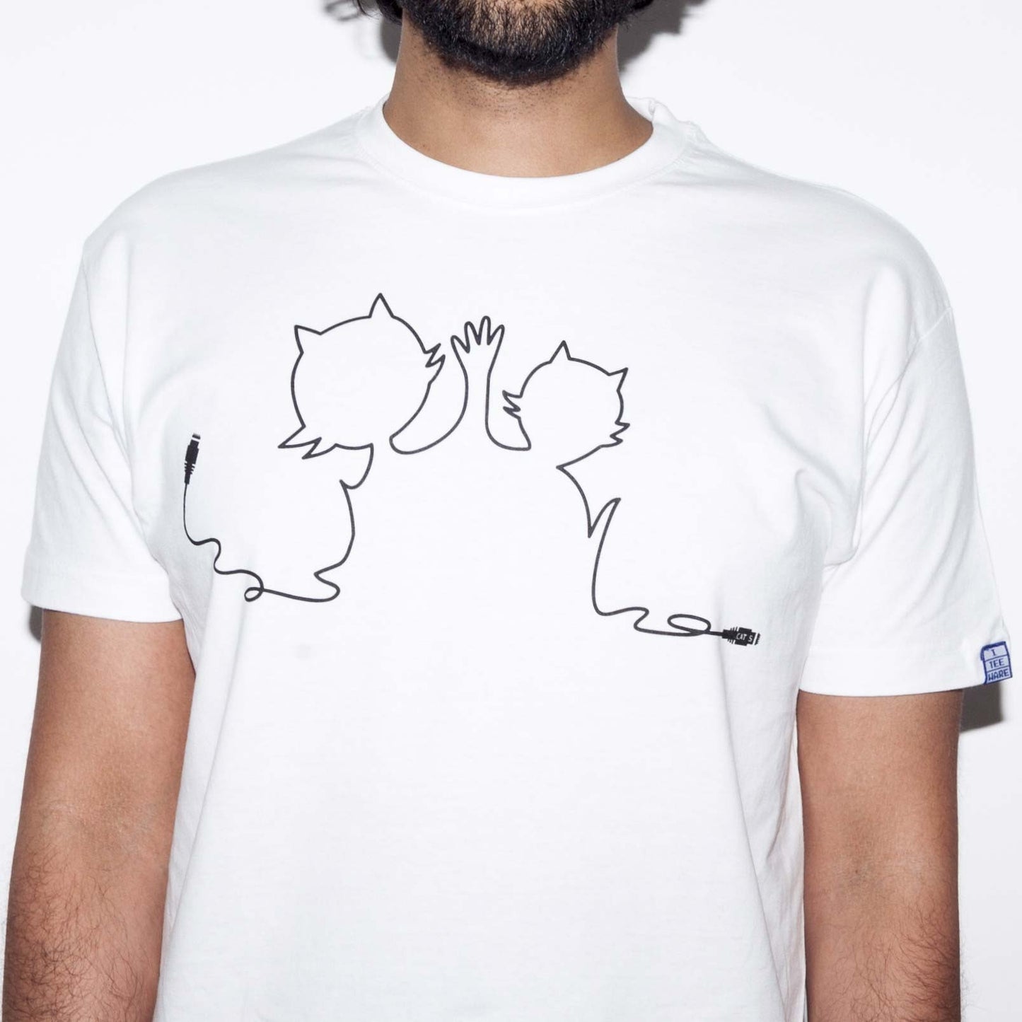 White T-shirt with a funny computer nerd Ethernet geek cat 5 cable joke screen printed in black on the front. A looping cable makes the shape of two cats giving a high five with cat 5 connector at either end.