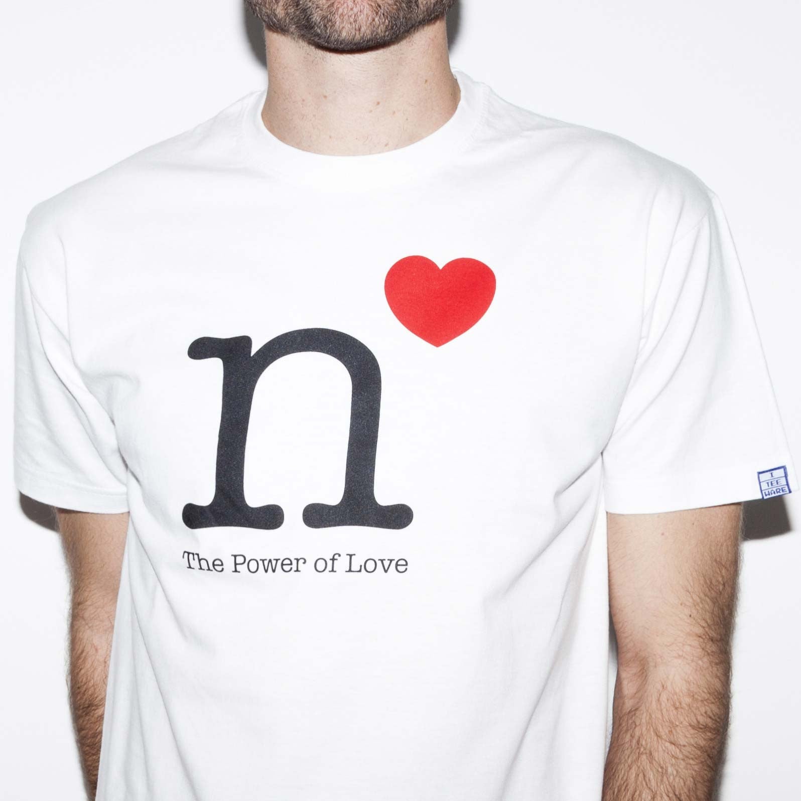 White T-shirt with funny math’s science power function joke about love screen printed on the front. A black lower case letter n with a red love heart above right with the slogan, Power of love - in black below